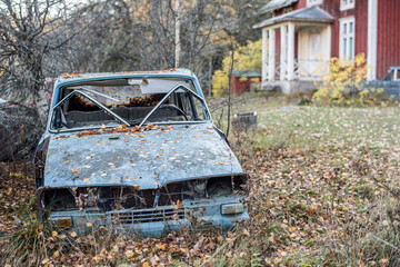 Car wrecks in the forest of Varmland during fall in Sweden