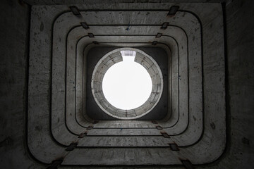 Bottom-up view inside a square subway ventilation shaft.
