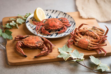 Deliciously cooked crabs on plates with lemons and herbs