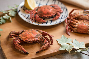 Deliciously cooked crabs on plates with lemons and herbs