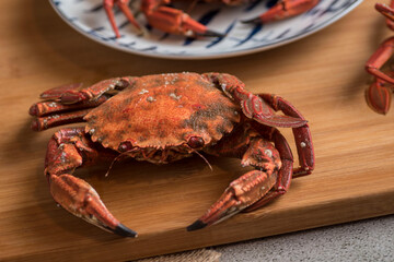 Closeup shot of a delicious red crab on a wooden board