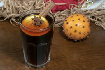 Warming winter drink with a cinnamon stick. Drink with cinnamon and star anise. Close-up.