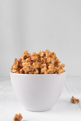 Caramel popcorn in a white bowl
