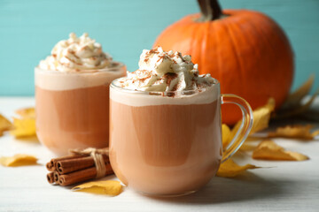 Delicious pumpkin latte on white table, closeup
