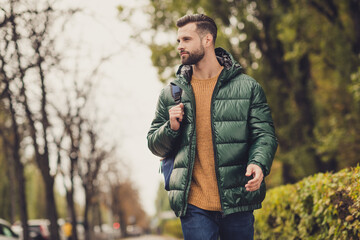 Portrait of positive young person look far away carry rucksack autumn weekend excursion walking outdoors