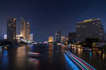 Fototapeta premium Bangkok city center financial business district, waterfront cityscape and Chao Phraya River during twilight
