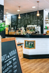 Empty cafe interior with coffee maker and blackboard with menu