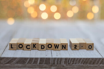 LOCKDOWN 2.0 covid pandemic order concept of wood block letters on board warm tones background