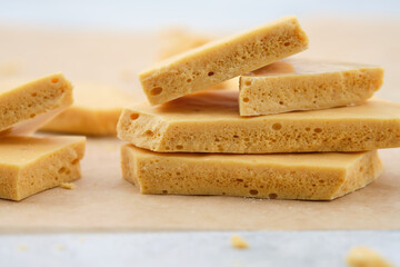 Dessert caramel honeycomb toffee on a white background.