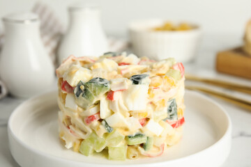 Delicious salad with fresh crab sticks on plate, closeup