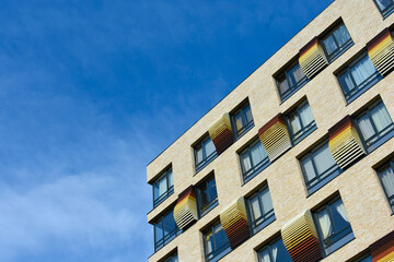 Beautiful modern house with big windows on a background of blue sky.