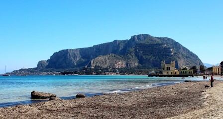 Mondello, Sicily, view of the beach and a seaside complex under a beautiful blue sky 
with Monte...