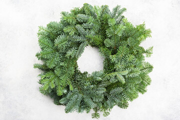 Handmade Christmas wreath on the white table, top view, selective focus