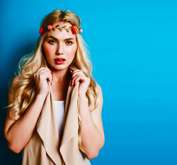 young blond woman dressed like ancient greek godess, jewelry close up isolated, beautiful girl hands manicured red nails on blue background copyspace