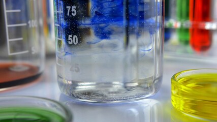 Stirring Blue Liquid Dye in Glass Beaker in Laboratory