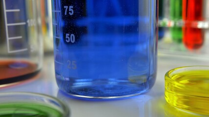 Stirring Blue Liquid Dye in Glass Beaker in Laboratory
