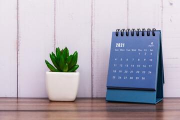 Month of April 2021 calendar blue color, rustic white color painted wood background.