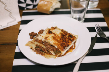 Piece of meat lasagne on the plate.