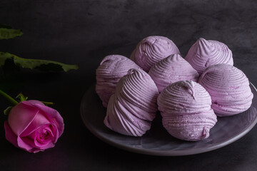 Blackcurrant marshmallows on a dark background.