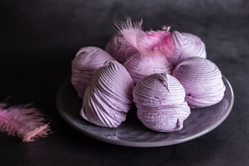 Blackcurrant marshmallows on a dark background.