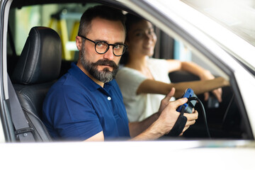 Professional car mechanic repair service and checking car engine by Diagnostics Software computer. Expertise mechanic working in automobile repair garage.