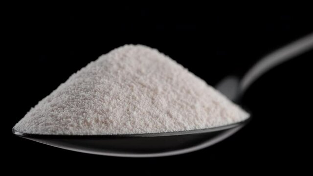 collagen. pour collagen powder in black spoon. Stylish video with collagen. Natural beauty and health supplement