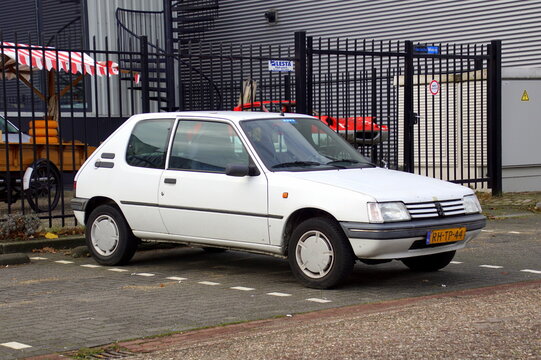 Naarden, the Netherlands - November 11, 2018: White Peugeot 205 on a public parking lot. Nobody in the vehicle.