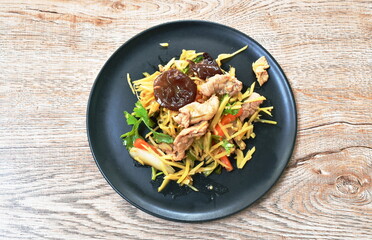 spicy fried pork with slice ginger and mushroom on plate