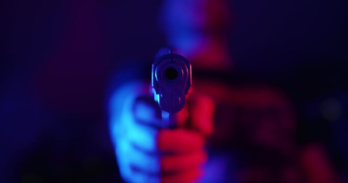 Man pointing a gun to the camera