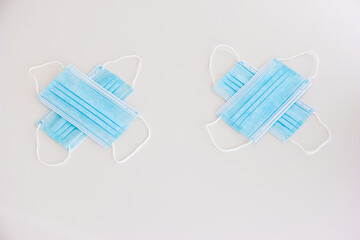 New blue textile medical face masks isolated on white arranged in emoji concept no people to view