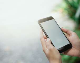 Hand image using smartphone, blurry background