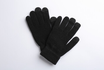 Pair of stylish woolen gloves on white background, flat lay