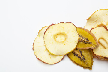 Fruit chips with apples, pineapple and kiwi on a white background. Top view on dried fruits. Healthy eating concept