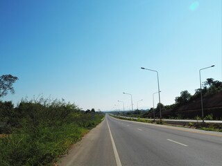 The entry road go to the mountains with blue sky