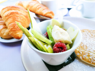 Breakfast with orange juice and fresh fruits on table