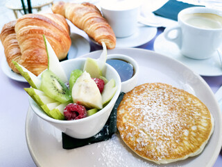 Breakfast with orange juice and fresh fruits on table