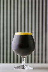 Glass of strong dark craft beer 