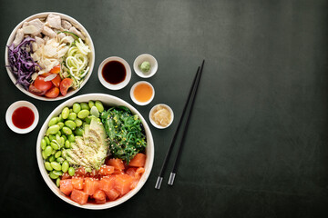 Top view of poke bowls composition with various sauces