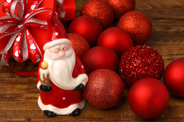 Santa claus with red chrismas baubles and boxes of presents