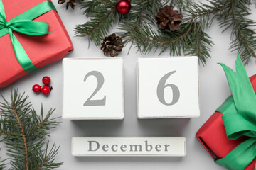 Flat lay composition with block calendar and gifts on white background. Boxing day concept