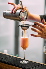 Barman making a sweet cocktail with shaker - obrazy, fototapety, plakaty