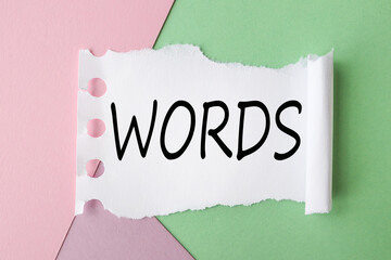 WORDS. text on white torn paper on colored background