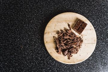 Chopped chocolate on kitchChopped chocolate on kitchen wooden board.en wooden board.