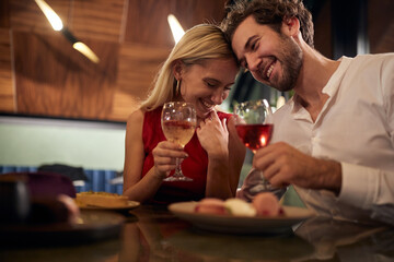 A young couple in romantic moments at Valentine's day celebration in restaurant. Together, Valentine's day, celebration