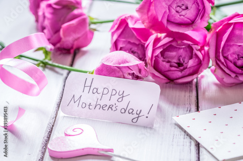 present design with Mother's day text and greeting-card on wooden desk