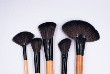 Closup head of Makeup brushes put on background