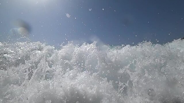 9x slow motion footage of coming wave at sunny day at sandy beach