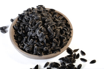 Sunflower seeds in a plate on a white background