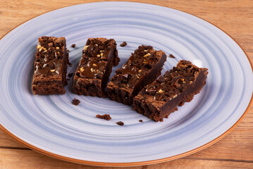 some brownie slices on a blue plate on wooden table
