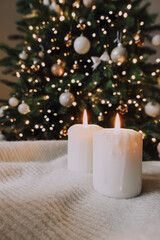 Obraz na płótnie Canvas Holiday candles on the background of a Christmas tree